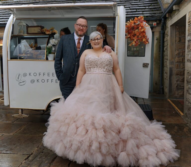 Bride and Groom posing infront of dessert truck. Koffee and Kreme. Wedding and event catering