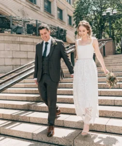 Wedding Photographer in York gets shot of bride and groom just married walking down steps