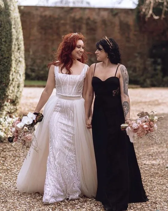 Bride and Bride in white and black wedding dresses side by side