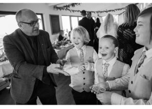Close Up Magician Jon Martin Magic performing trick on young wedding guests