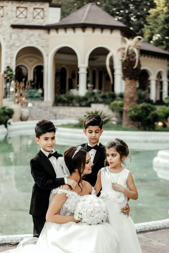 Bride and groom posing for picture with page boy and bridesmaid. What is a page boy blog.