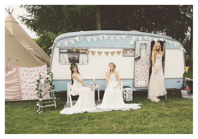 Brides posing infront of Daisy Vintage Caravan Photo Booth 