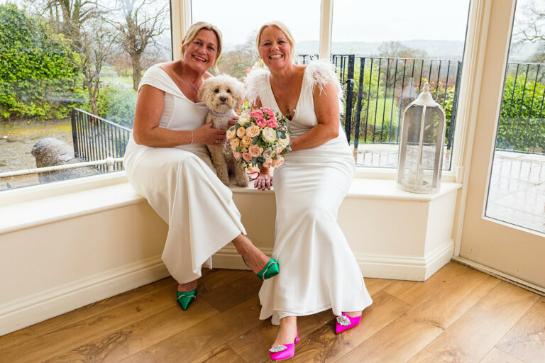 Brides sat with puppy by Jane Ball Photography Logo