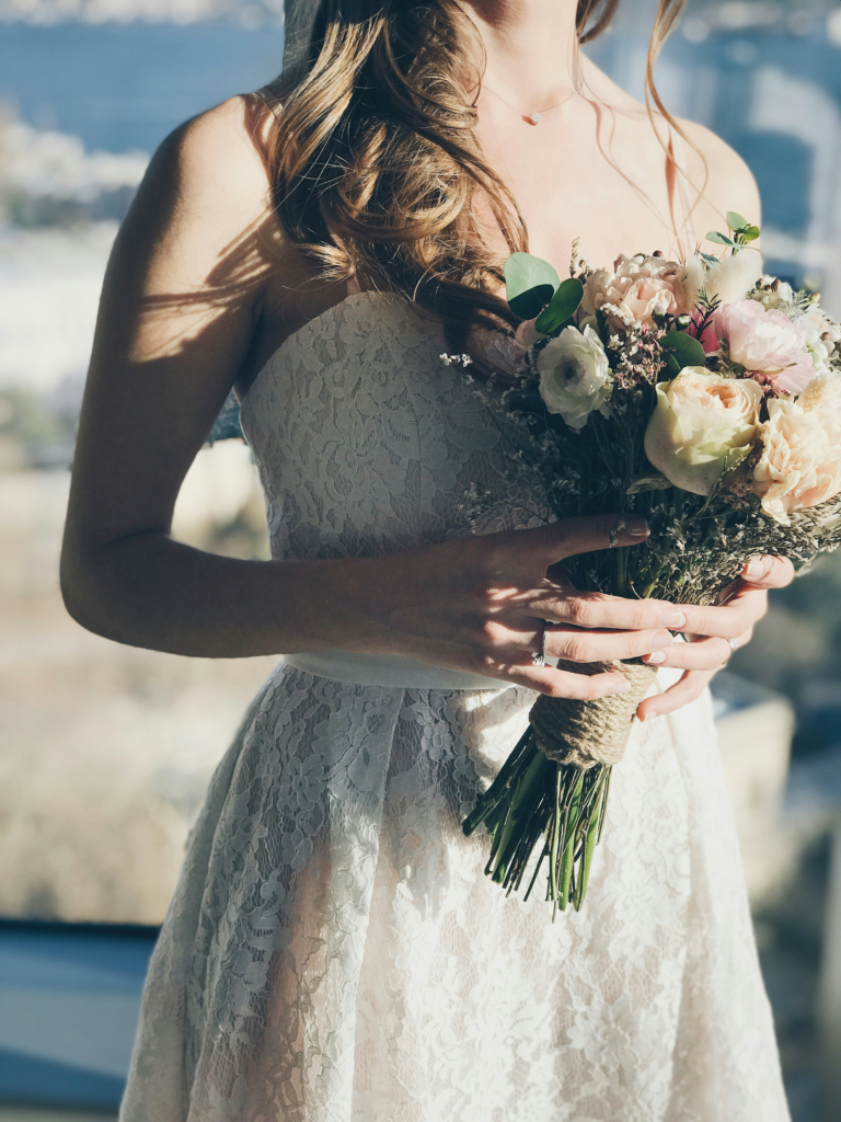 Weddings under 10k guide. Bride holding DIY bouquet
